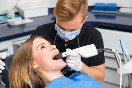 Zahnarzt, der die Zähne des Patienten mit CEREC<sup>®</sup> Scanner scannt